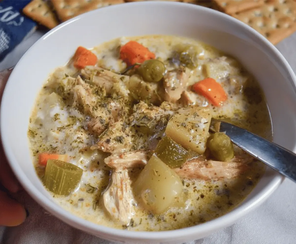 Creamy slow-cooker keto chicken pot pie soup in a bowl, featuring tender chicken, vegetables, and a savory broth perfect for low-carb comfort meals.