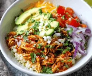 Delicious chicken enchilada bowls served with cauliflower rice, topped with melted cheese, fresh cilantro, and diced tomatoes for a healthy, flavorful meal.