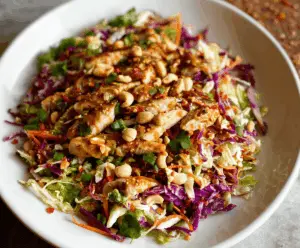 Crunchy Chinese Chicken Salad with crisp vegetables, shredded chicken, and sesame dressing on a plate