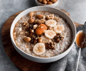 Creamy Instant Pot Bone Broth Oatmeal in a bowl topped with fresh herbs and vegetables, ready to serve.