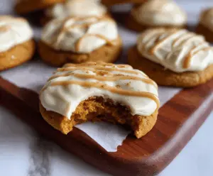 Delicious pumpkin cookies topped with creamy maple cream cheese frosting, perfect for fall desserts