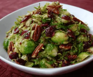Delicious Brussels sprouts with pecans and cranberries, inspired by Alton Brown's recipe.