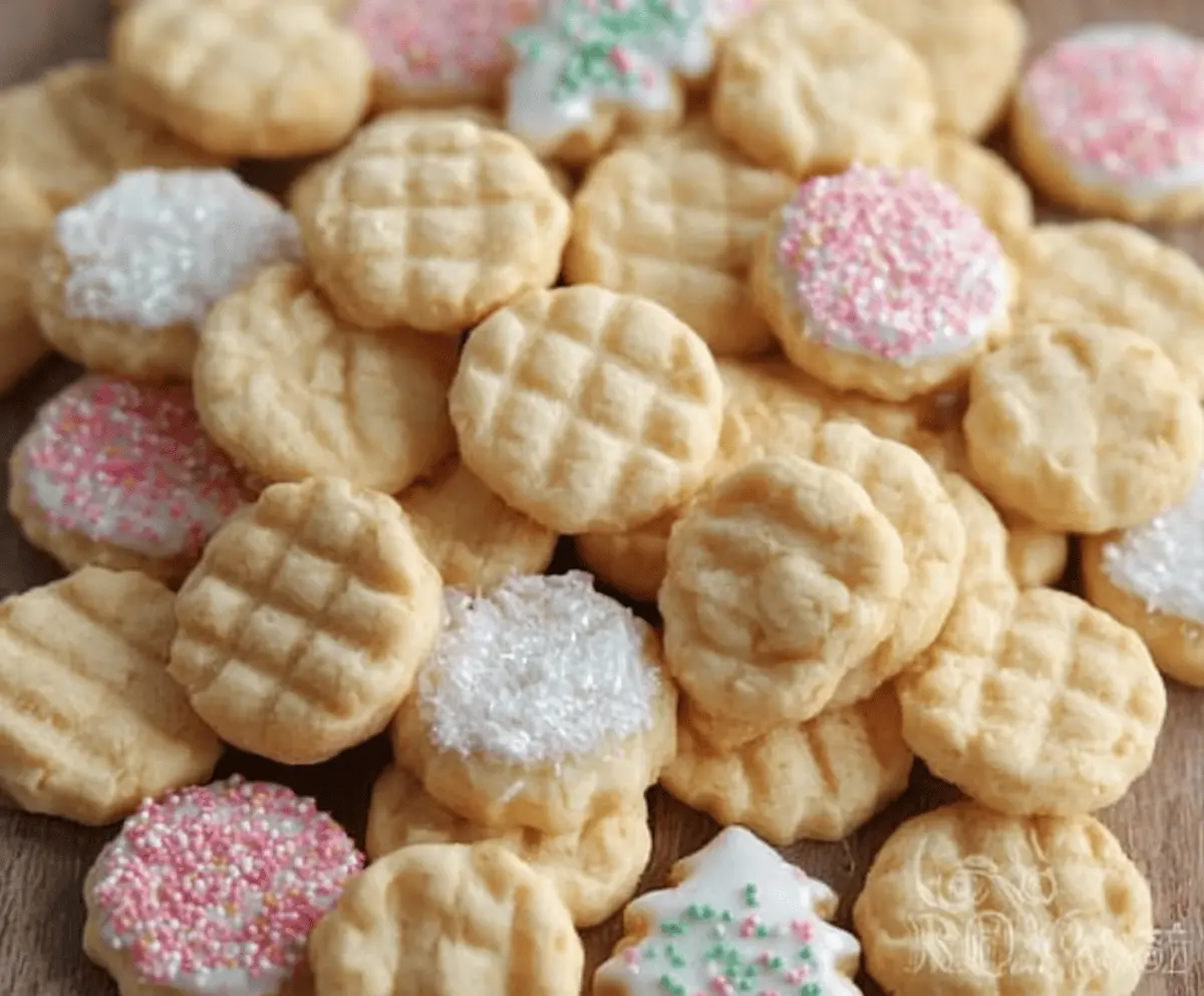 Delicious mini sugar cookies with a golden-brown finish, perfect for snacking or gifting.