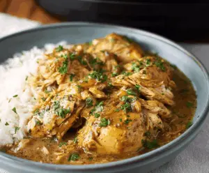 Tender slow cooker chicken topped with rich gravy, perfect for comforting meals