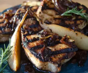 Delicious grilled pork chops served with balsamic caramelized pears on a rustic plate.