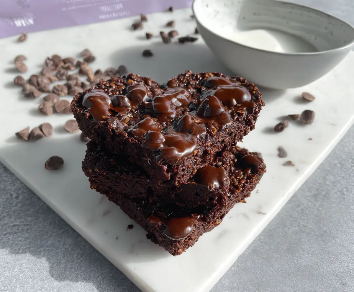 Healthy Chocolate Brownie overnight Weetbix served in a bowl with fresh berries and a drizzle of honey