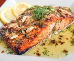 Delicious Lemon Dill Salmon with Garlic, White Wine, and Butter Sauce on a plate