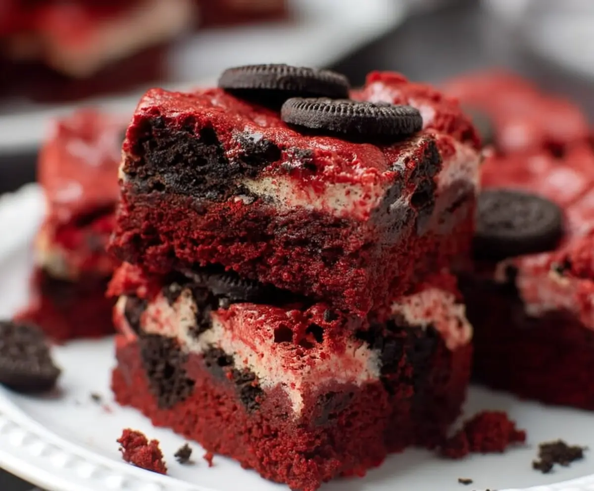 Delicious Oreo Red Velvet Brownies with creamy frosting and crumbled Oreos on top.