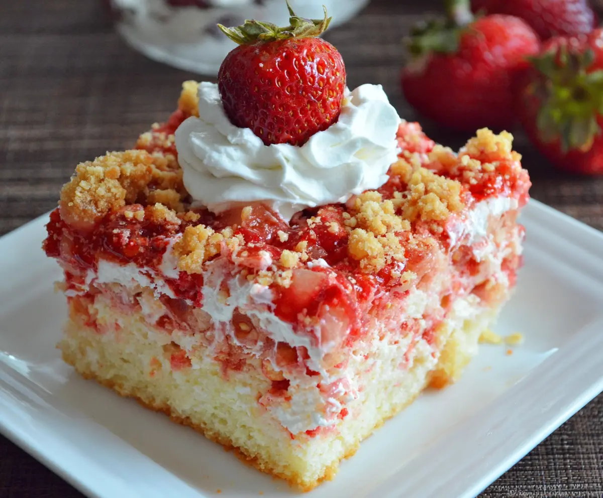 Delicious Strawberry Crunch Poke Cake with fresh strawberries and crunchy topping