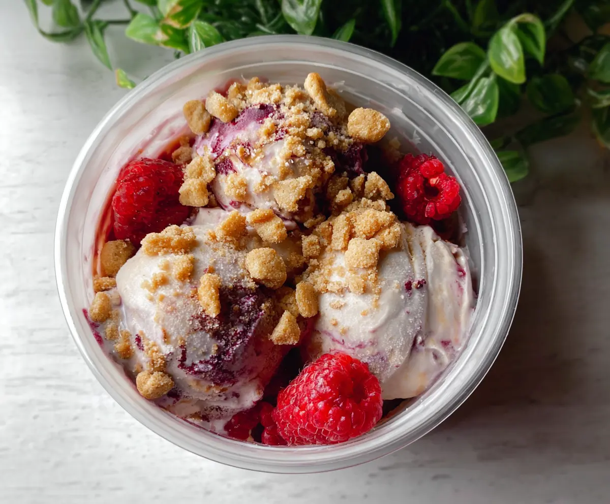 Delicious Berry Crumble Ice Cream served in a bowl, showcasing fresh mixed berries and a crunchy crumble topping.